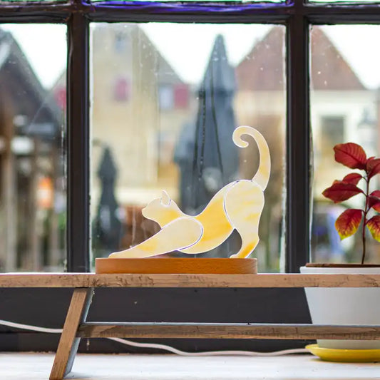 Stretching cat on wooden stand